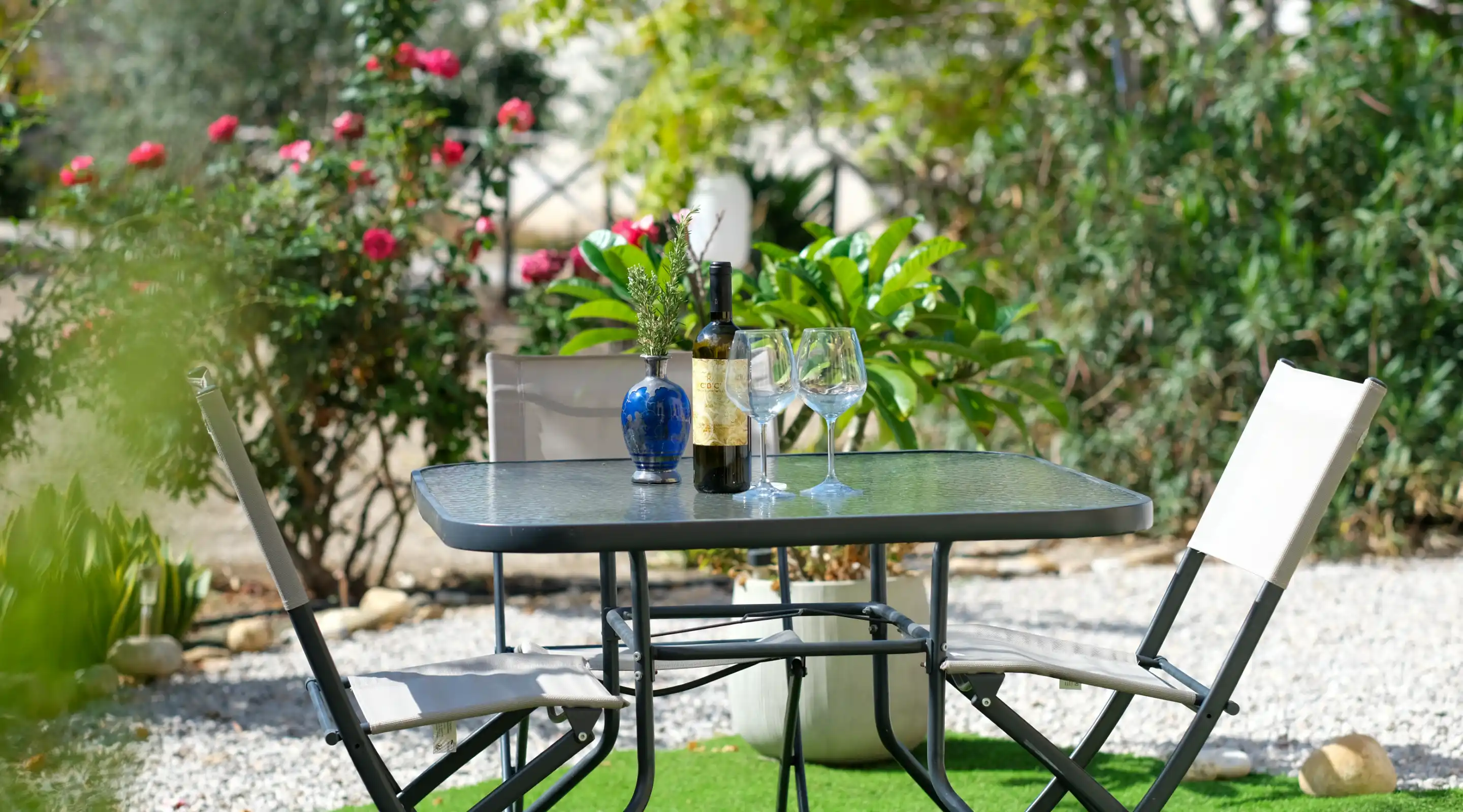 Outdoor garden dining area with wine setup at Villa Porta Azzurro in Sicily